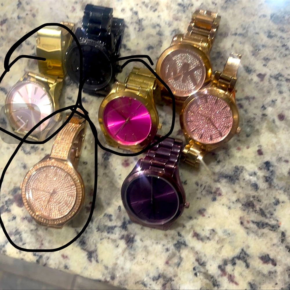 Six Michael Kors watches and one Nixon watch. All clean